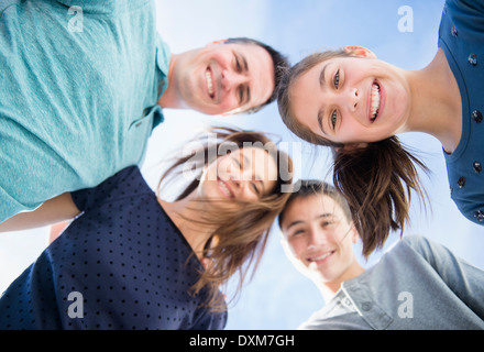 Portrait of smiling Caucasian family in huddle Stock Photo
