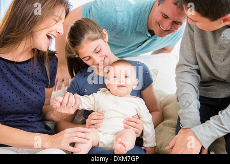 Caucasian family playing with baby girl