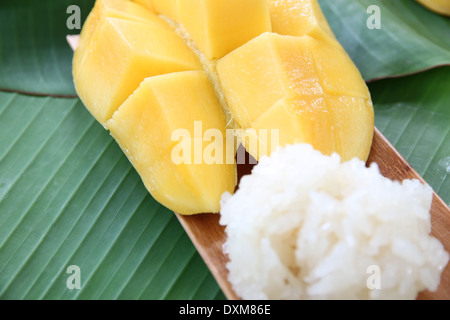 Ripe mango and sticky rice in bamboo dish on banana leaves,local Thai foods. Stock Photo