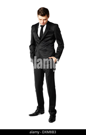 Young businessman looking down. Man against white background Stock Photo