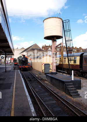 Steam train and water tower, Paignton railway station, Devon, UK Stock Photo