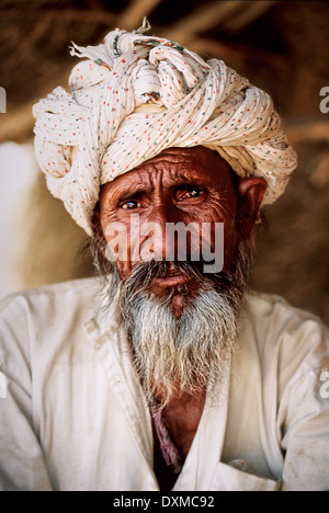 Elderly Indian man with salt-and-pepper beard in a village near Jodhpur, India. Digitally Manipulated Image. Stock Photo