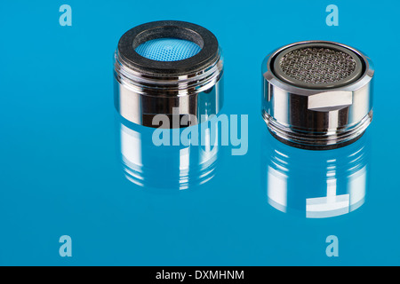 Macro of two faucet aerators for reducing water consumption. Stock Photo
