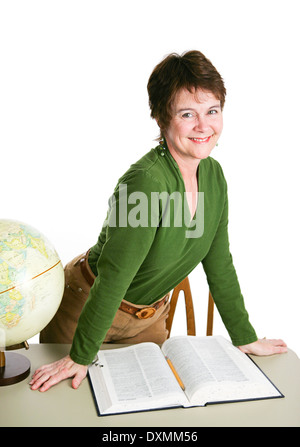 Pretty mature teacher or librarian at her desk reading a book. Isolated on white.  Stock Photo