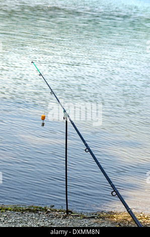 A long fishing rod standing on a beach Stock Photo - Alamy
