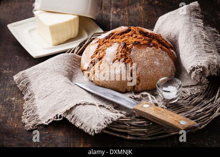 Rye bread and butter on wooden table Stock Photo