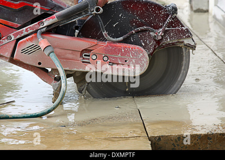 a large concrete cutting machine cutting the concrete Stock Photo