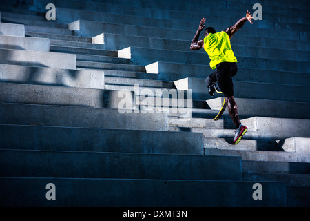 A wounded veteran athlete trains on stadium stairs. Stock Photo