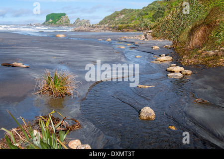 Small Stream Flowing Into the Sea Stock Photo