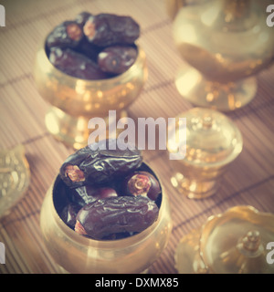 Dried date palm fruits or kurma, ramadan food which eaten in fasting month in retro effect. Stock Photo