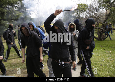 Madrid, Spain. 27th Mar, 2014. A student waves a smoke flare during the second day of student strikes to protest against the government education reform and cutbacks in grants and staffing, at Complutense University in Madrid, Spain, Thursday, March 27, 2014. Credit:  Rodrigo Garcia/NurPhoto/ZUMAPRESS.com/Alamy Live News Stock Photo