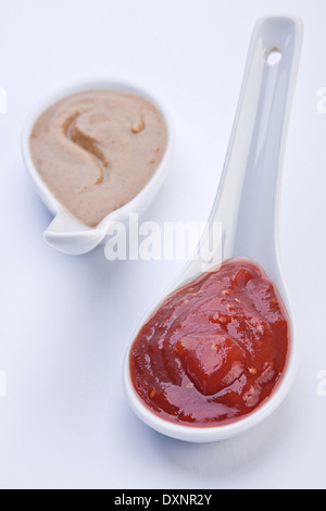Ketchup in white ceramic spoon Stock Photo