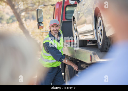 Roadside mechanic towing car for senior couple Stock Photo