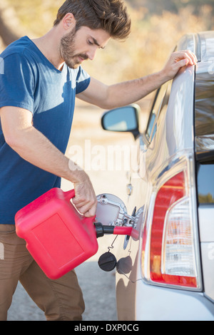Man filling gas tank at roadside Stock Photo