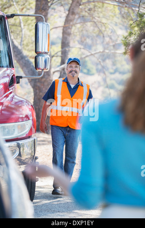 Roadside mechanic arriving to help woman Stock Photo