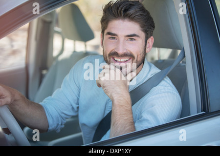 Portrait of smiling man driving car Stock Photo