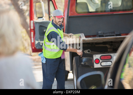 Roadside mechanic preparing to tow car Stock Photo