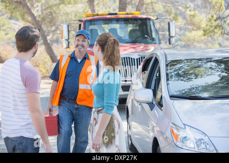 Roadside mechanic arriving to help couple Stock Photo