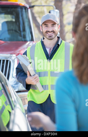 Roadside mechanic arriving to help woman Stock Photo