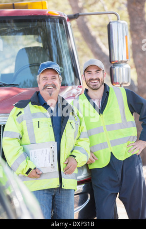 Portrait of confident roadside mechanics Stock Photo