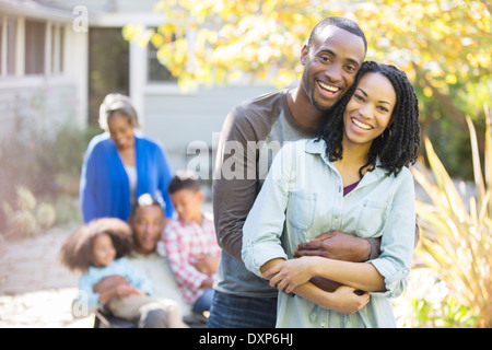 Portrait of happy couple hugging outdoors Stock Photo