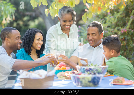 Happy family eating lunch at patio table Stock Photo