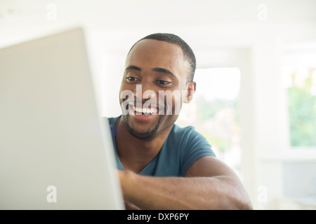 Happy man using laptop Stock Photo