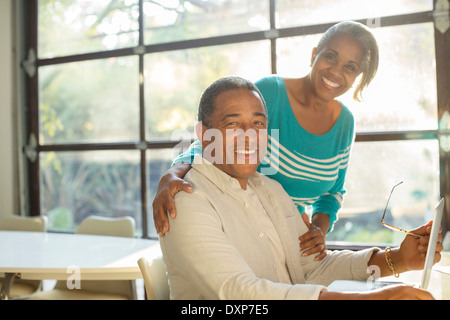 Portrait of smiling senior couple at laptop Stock Photo