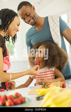 Happy family eating strawberries Stock Photo