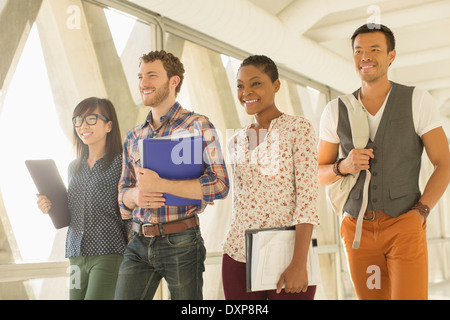 Confident casual business people walking in office corridor Stock Photo