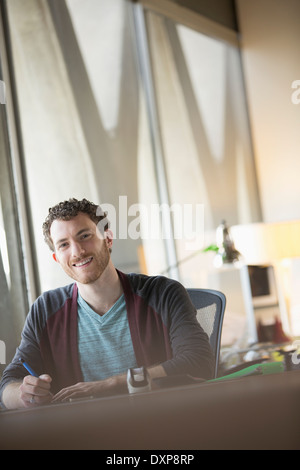 Portrait of confident businessman working at desk Stock Photo