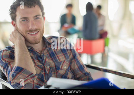 Portrait of confident casual businessman with paperwork Stock Photo