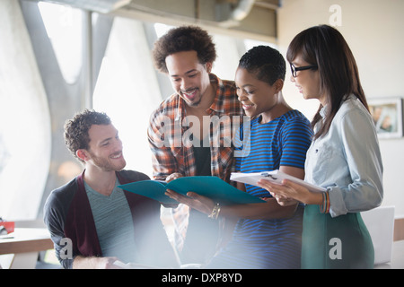 Creative business people reviewing paperwork in meeting Stock Photo
