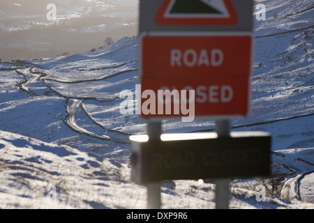 Road sign showing closure of the kirkstone pass mountain highway mid winter in the lake district england Stock Photo