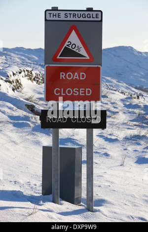 Road sign showing closure of the kirkstone pass mountain highway mid winter in the lake district england Stock Photo