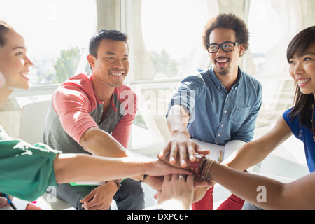 Creative business people connecting hands in huddle Stock Photo