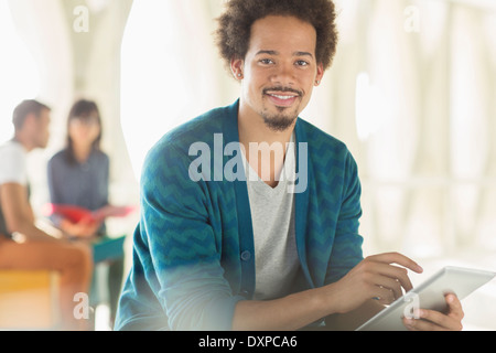 Portrait of casual businessman using digital tablet Stock Photo