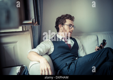 elegant attractive fashion hipster man on the phone at home Stock Photo