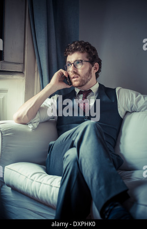 elegant attractive fashion hipster man on the phone at home Stock Photo