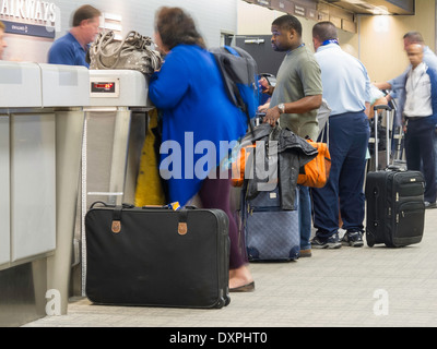 People Waiting in Line with Luggage at the Tampa International Airport, Tampa, FL Stock Photo