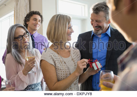 Woman opening gift box at birthday party