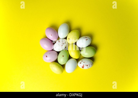 Multi coloured easter eggs confection at yellow background Stock Photo
