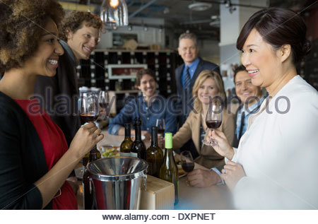 Sommelier and couples wine tasting in store