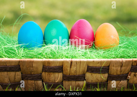 Four Easter Eggs in a basket on a grass Stock Photo