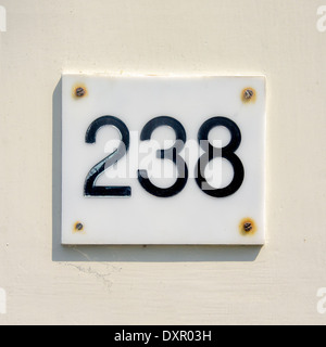 House number two hundred and thirty eight. Black lettering engraved in a white plastic plate Stock Photo