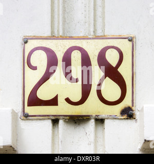 House number two hundred and ninety eight. Brown lettering on a yellowish enameled plate. Stock Photo