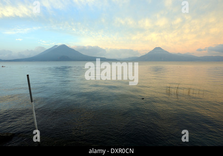 Early morning view across Lake Atitlan from Panajachel. To the left are Volcan Toliman, 3153m,  and, behind it,  Volcan Atltlan Stock Photo