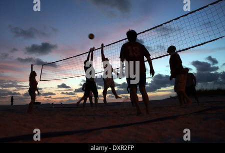 Cocoa Beach, Florida, silhouette, people playing beach volleyball in the evening