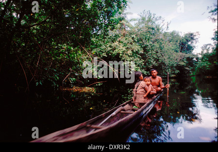 warao indians in a dugout canoe, orinoco river delta