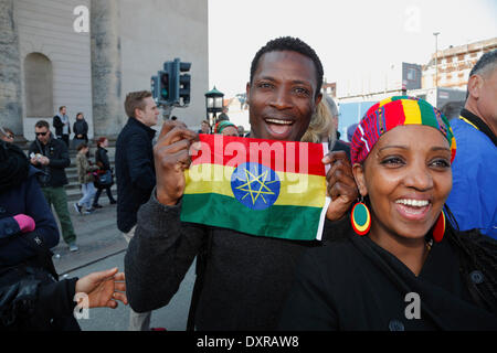Copenhagen, Denmark. 29th March, 2014. The runners in the IAAF/AL-Bank World Half Marathon Championships 2014 ran in the streets of sunny Copenhagen with start and goal at the Christiansborg Palace Square. The elite women and men were followed by nearly 30,000 recreational and sub-elite runners. Cheering Eritrean dedicated fans with flags and colours near the finish line at the Christiansborg Palace Square celebrating good news on the large video screen about the Eritrean runners. Credit:  Niels Quist/17�Թ����� Live News Stock Photo